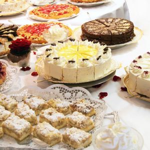 Cake buffet with various cakes decorated with flowers