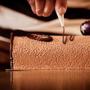 Pastry in his workshop preparing Chocolate Yule logs